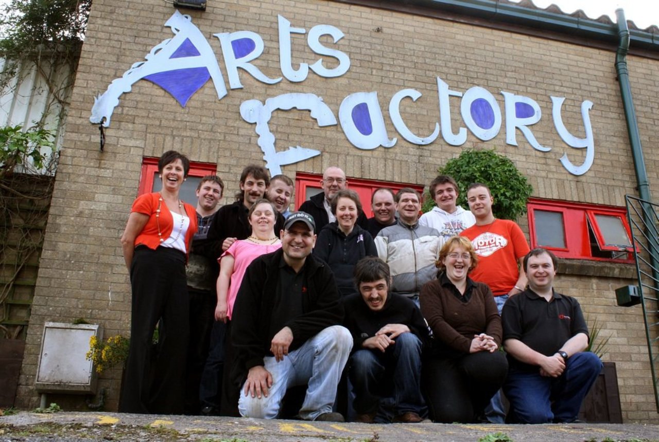 A group of people standing outside the Arts Factory charity
