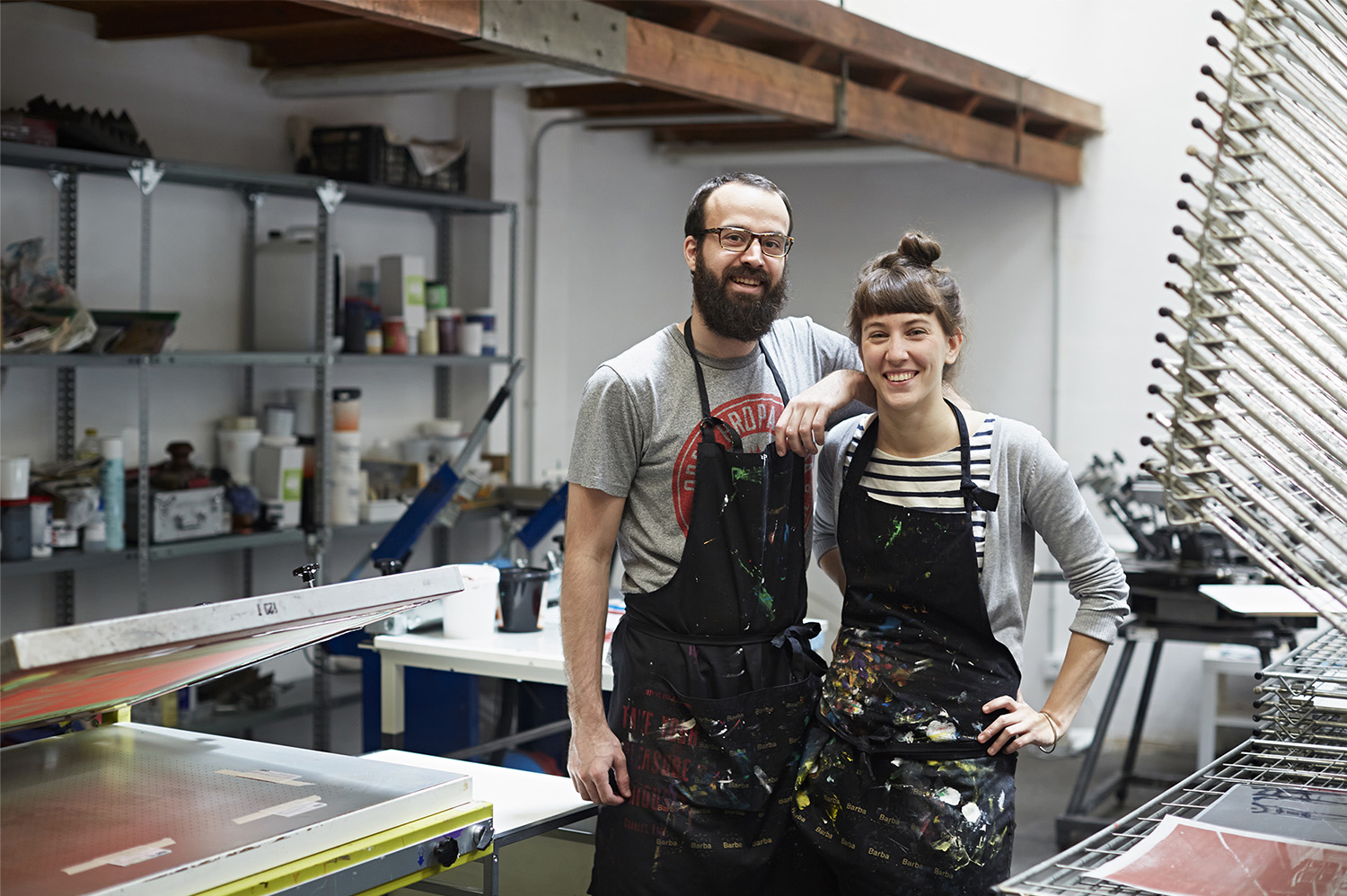 Two people standing in a workshop