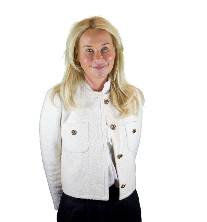 Trustee Anna Moulton wears a white denim jacket and smiles at the camera