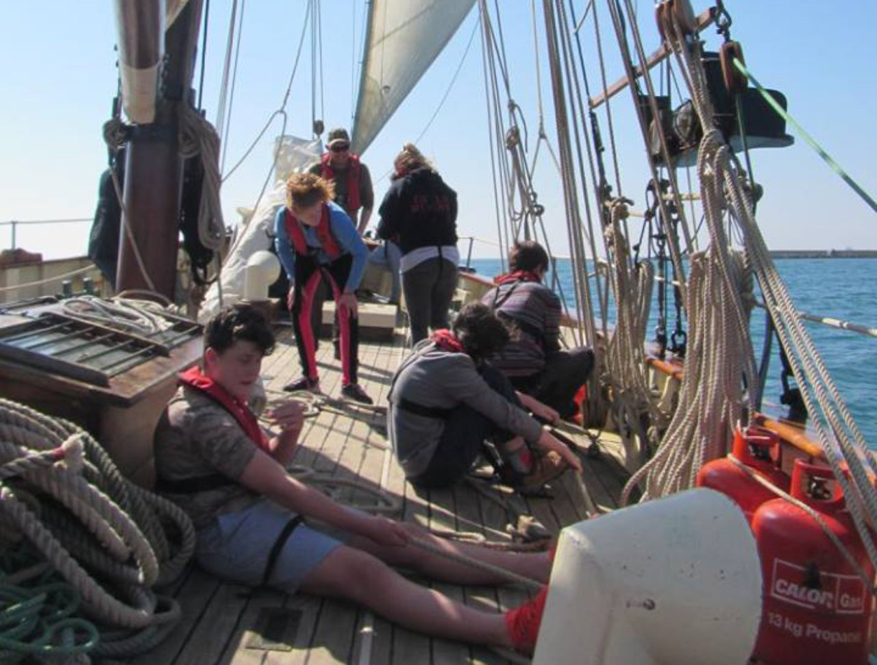 Young people sitting on a boat