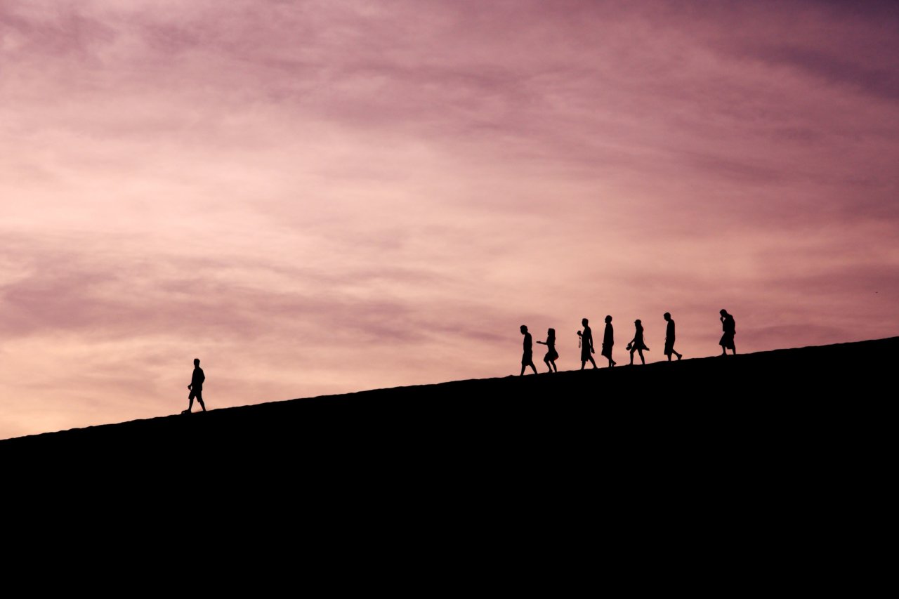 One man leading and a group of people following