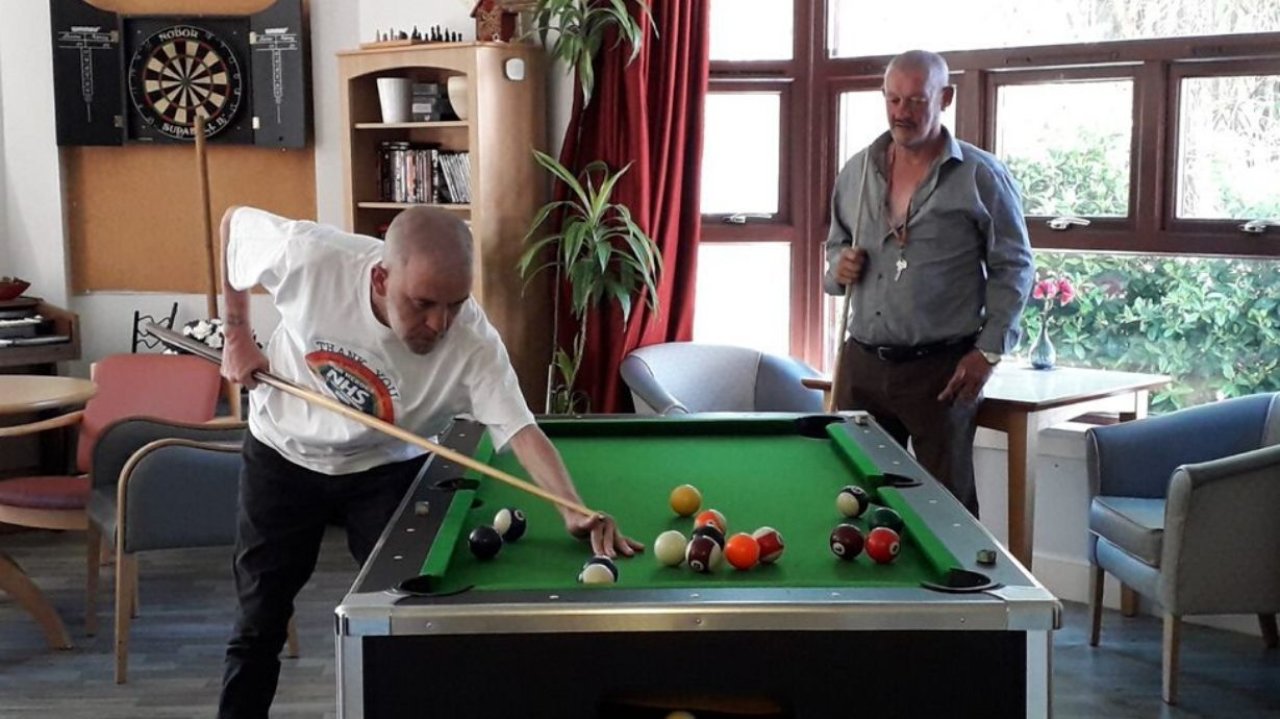 Two men playing snooker