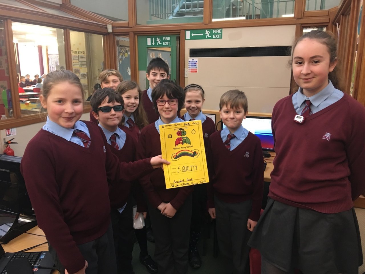 A group of children holding an equality poster