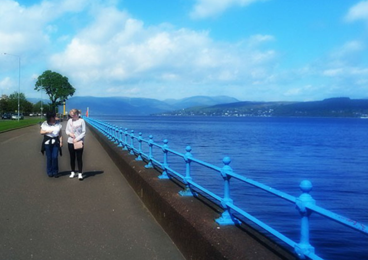 Two people talking near the sea