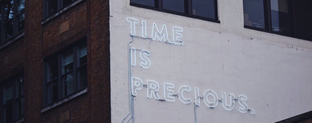 'Time is precious' written on a building