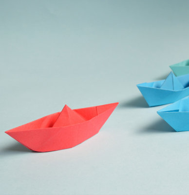 Paper boats going in one direction