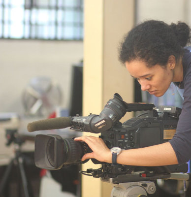 A girl focussing a film camera