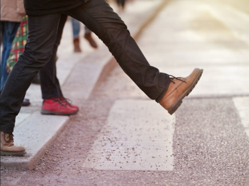 A person walking across the road