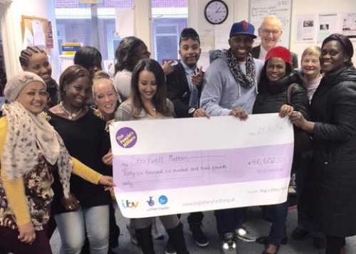 A group of people holding a cheque