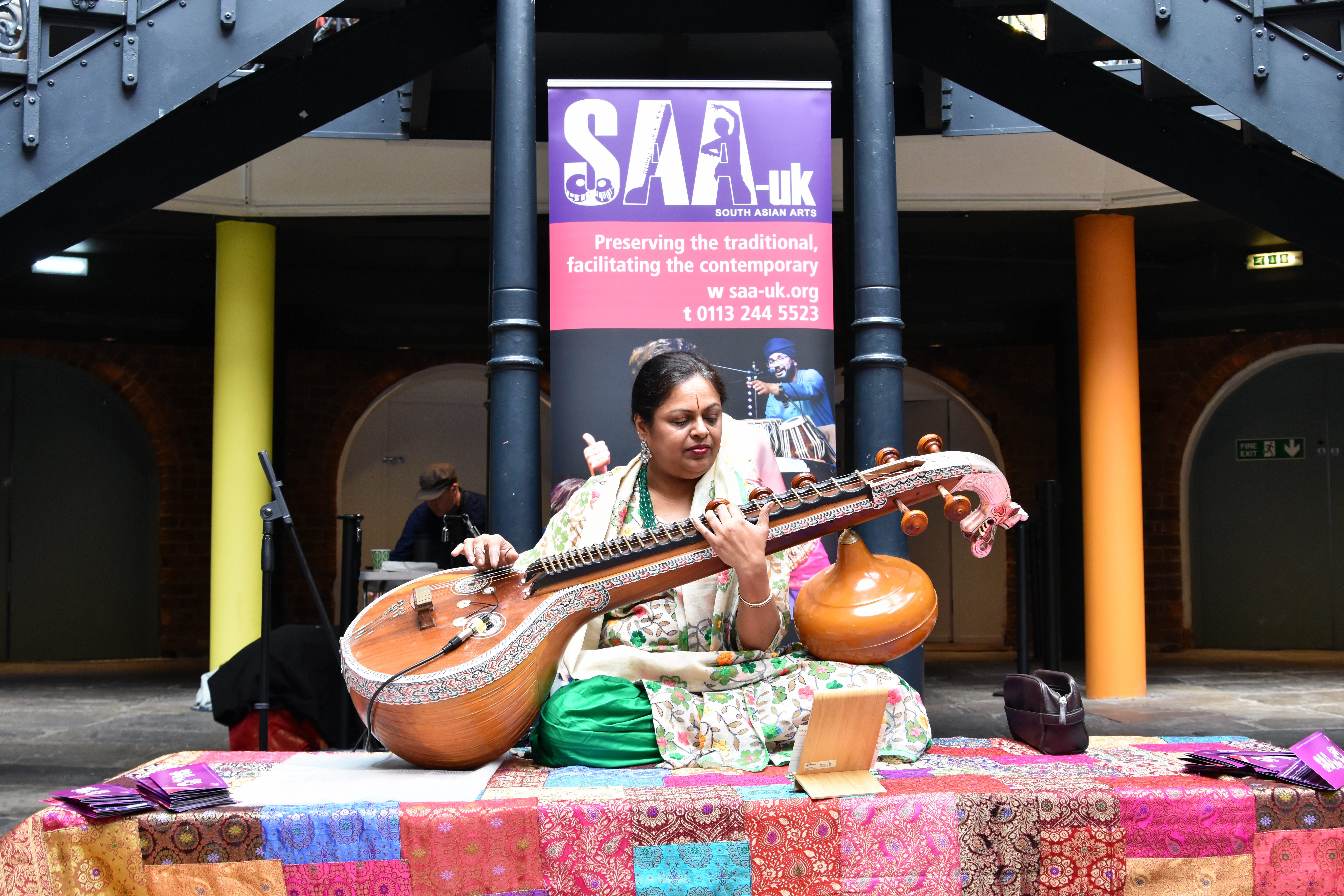 An Asian woman playing the sitar